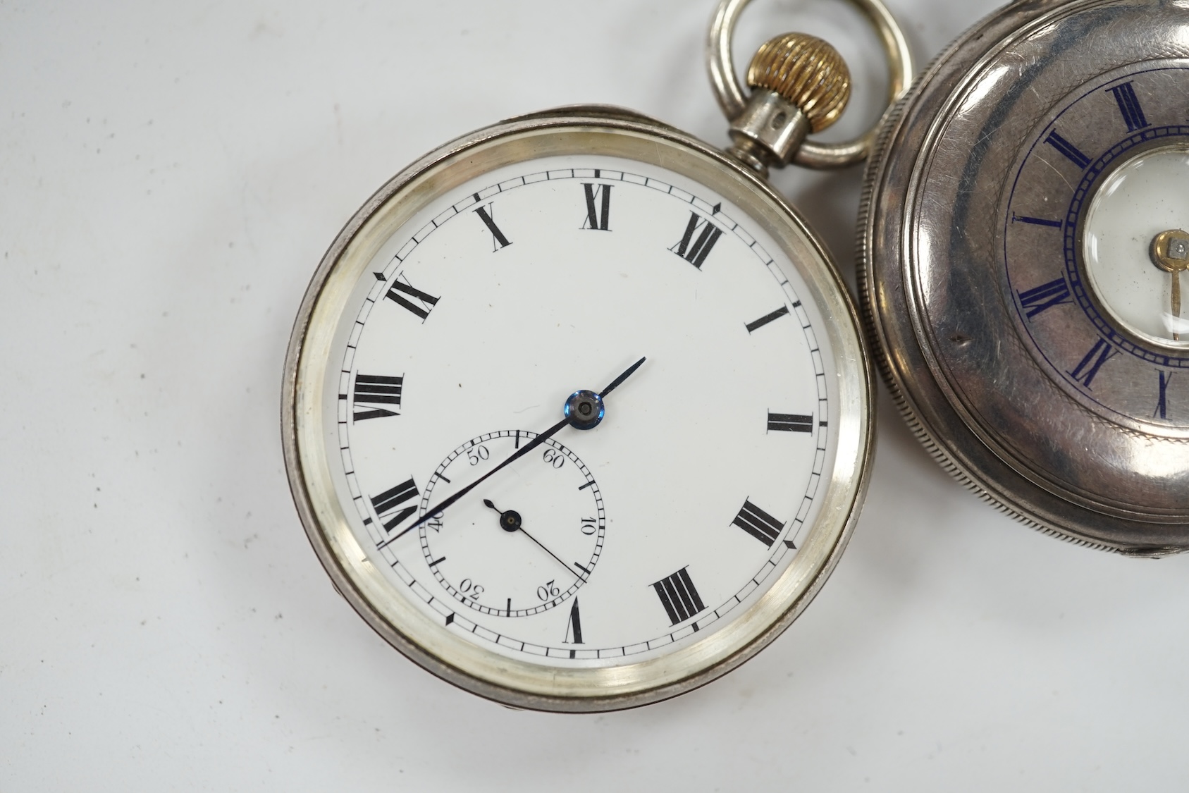 A late Victorian silver half hunter pocket watch and a later silver open faced pocket watch. Condition - poor to fair